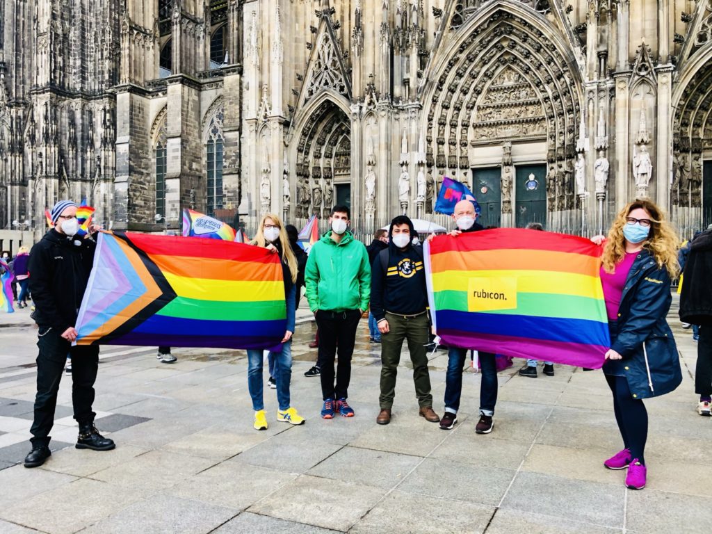 Foto mit Regenbogenflaggen vor dem Dom